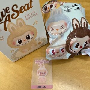 The Monsters Labubu Have a Seat pink “Dada” plush pendant blind box